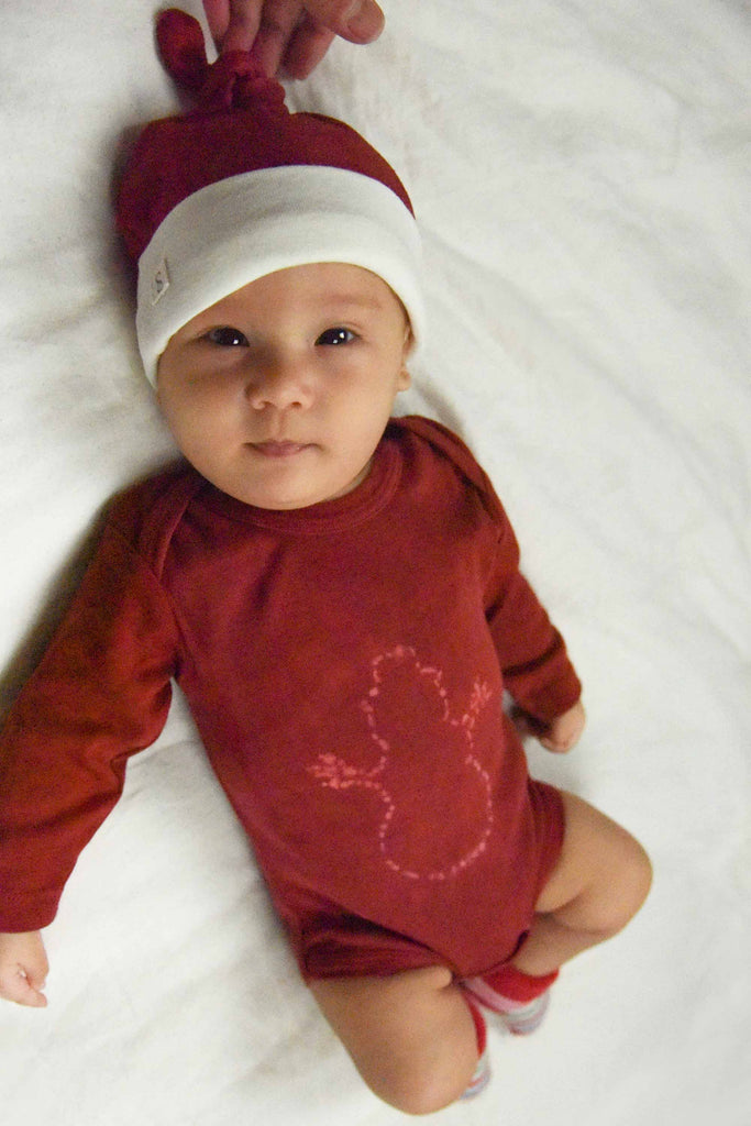 naturally plant-dyed organic cotton kid's clothing, baby long sleeve onesie dyed with madder roots